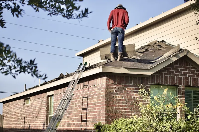 Professional roofer working on a residential roof in Solvang